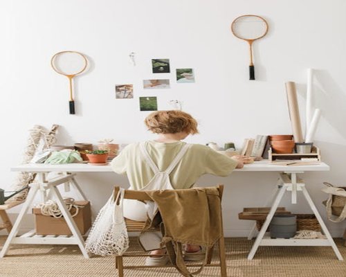 An individual sitting with good posture at a home office setup